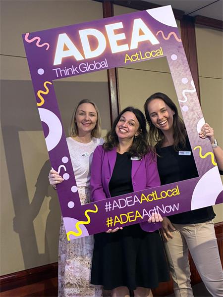 Our CEO and two Board Members sharing a smile behind the “Think Global. Act Local.” photo frame at the 2026 QLD State Conference. The trio looks relaxed and engaged, capturing the collaborative energy of the event.
